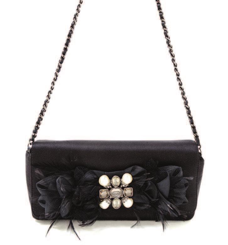87 89 87 A Chanel Black Satin Evening Handbag, 2008-2009, with a grosgrain, feather, faux pearl and silvertone decorative flap, a snap closure, a black leather woven chain strap and two interior slip