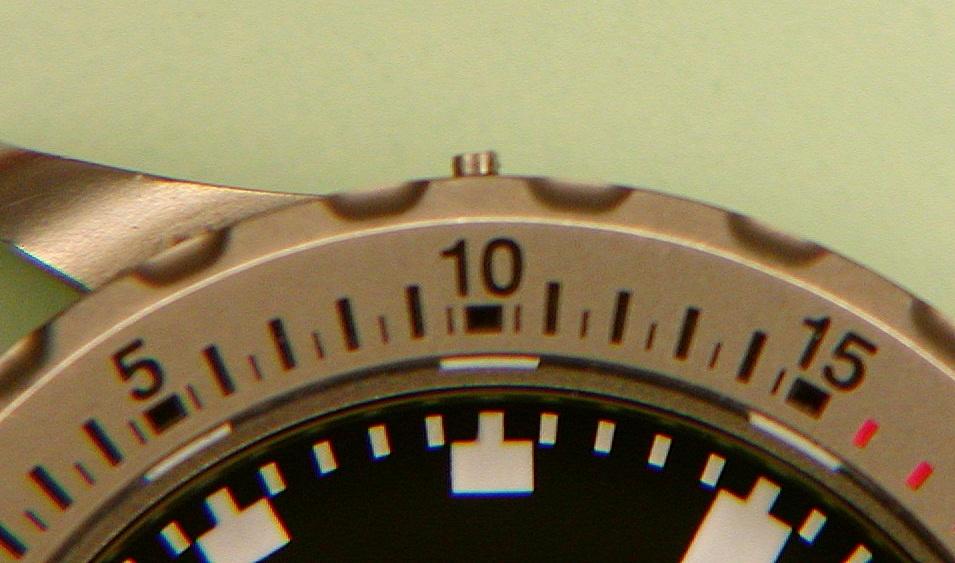 There are four screws in the bezel at 0 (index), 10, 30, and 50. Leave the screw under the triangle at 0 alone.