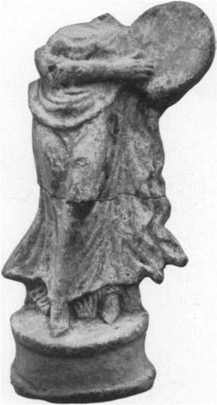 60 LUCY T. SHOE MF 4 Dancing Figure (Fig. 4). Height 0-215 m.; head, neck, right shoulder, and upper arm missing; broken in half and repaired; dark red clay.