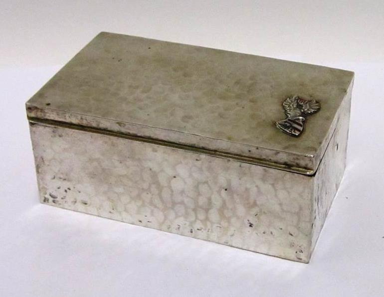 SILVER CIGARETTE OR CIGAR BOX '800' Standard and inscribed, 'Carl Werner, Heideberg', with hammered finish and gilt interior, the cover applied with an enamel German coat of arms, and "j'y pense" to