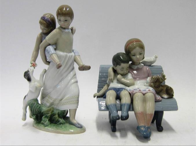 of two girls with a puppy, the larger 22cm high 188 TWO LLADRO PORCELAIN MODELS OF YOUNG GIRLS One seated on a basket with a squirrel; the other of two girls