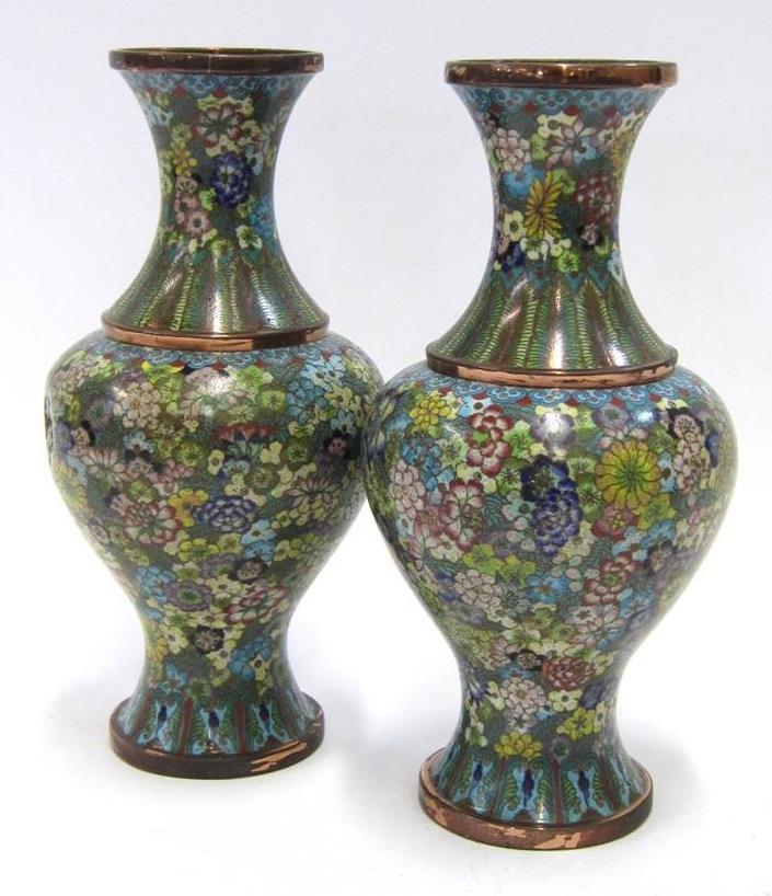 high (both with dent to body) Lot 216 216 A PAIR OF 20TH CENTURY CLOISONNE ENAMEL VASES Decorated with chrysanthemums and other flowers on a red