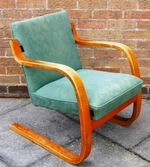 MRS PUNCH 27cm high Lot 347 347 ALVAR AALTO FOR FINMAR LTD A model '402' bent plywood armchair, upholstered in green geometric