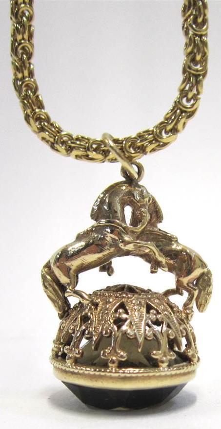 SMOKEY QUARTZ FOB SEAL Modelled with a pair of rearing horses, on gilt-metal chain 50-70