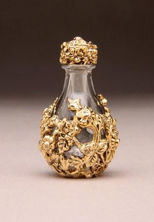 The Victorian Tear Bottle TM Line A filigree design of flowers and leaves wrap around these petite cobalt or clear glass bottles. Timeless Traditions tear bottles are approximately 2 high.