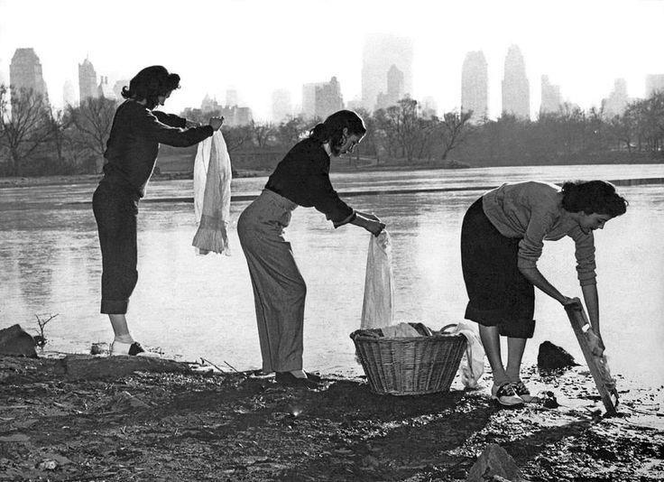 Three young women wash their clothes in