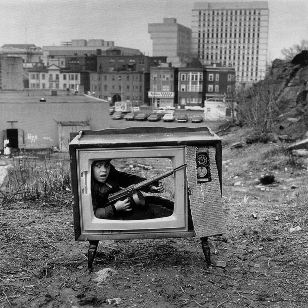 Boy hiding in a TV set.