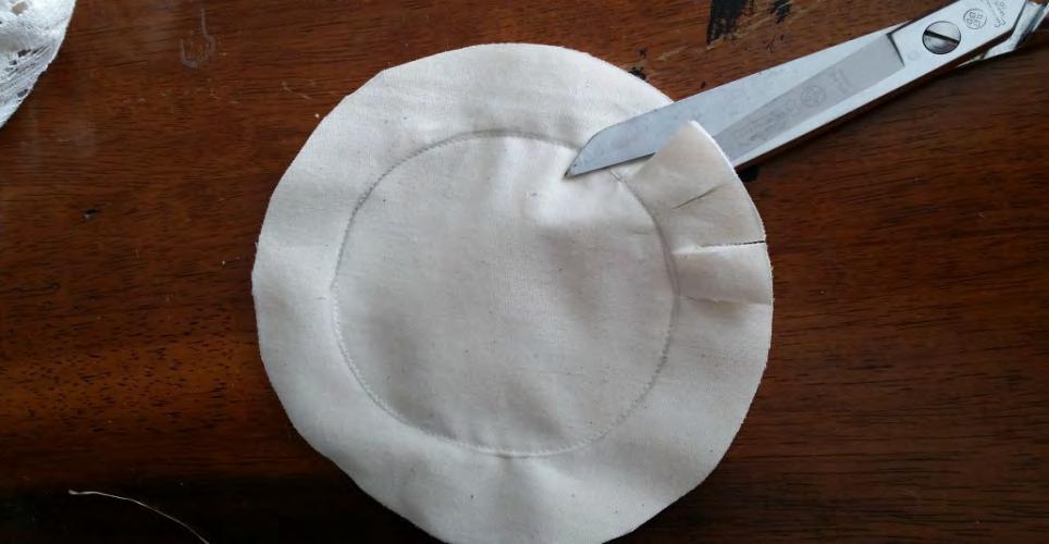 take your scissors and cut through all 3 layers up to seam line of