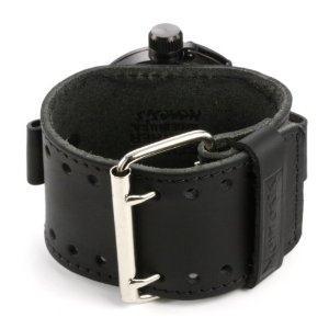 The watch case is attached on top of the strap, so the strap is between the