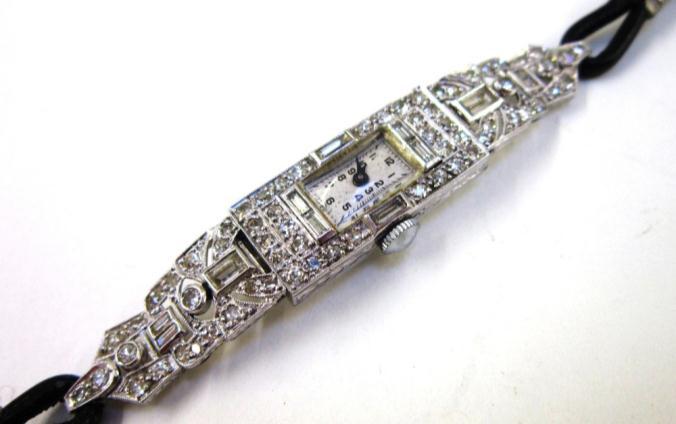 89. An unmarked silver Ring, set with a single emerald cut Citrine or smokey quartz 30-50 Lot 90 90. A Ladies Art Deco platinum and diamond Cocktail Watch, circa 1920.