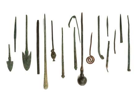 56 57 58 59 56 A GROUP OF BRONZE PINS, IMPLEMENTS AND ARROW HEADS Circa 10th Century BC to Roman Period Including a Persian gilt bronze cosmetic implement and container, a Roman bronze writing