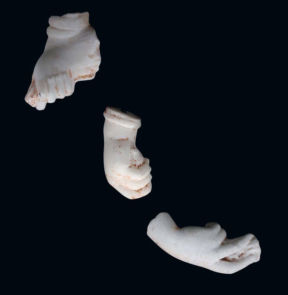 105 A ROMAN MARBLE HAND FRAGMENT Circa 1st-2nd Century A.D. Bent at the wrist, the delicate index and middle fingers extend to hold a curved object with the thumb resting on above, 12cm long.