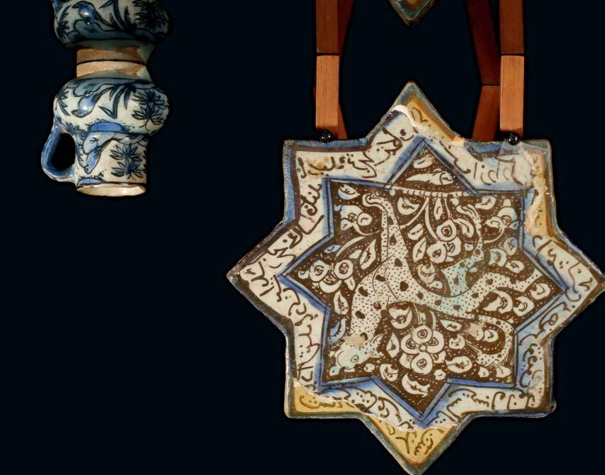 133 A KASHAN LUSTRE POTTERY STAR TILE Persia, 12th-13th Century In the shape of an eight-pointed star, decorated with a feline on a floral background, the border with a band of script, 20.