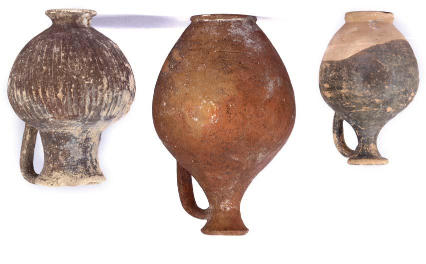 135 TWO CYPRIOT POTTERY BLACK BURNISHED VESSELS Bronze Age, circa 2nd Millennium B.C. A hemispherical spouted vessel with an incised geometric design and a small attachment opposite the spout, 30cm diameter including spout, 13.