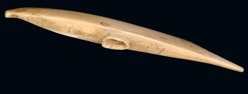 183 A FINE ALEUT WALRUS IVORY SEA OTTER CHARM OR AMULET, ALASKA Circa 19th Century With bead eyes, the front paws raised to the chin, with striated ribs flanking a row of beads, the reverse with a