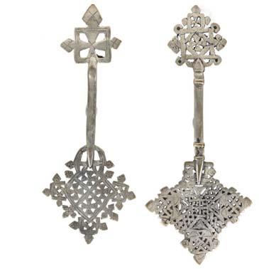 1,000-1,500 186 AN ETHIOPIAN COPTIC CROSS Late 19th Century-early 20th Century Silver plate with an engraved reticulated design, Handcrosses such as this were owned by