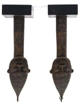 60-80 209 209 TWO BENIN BRONZE FIGURES The first wearing a tall headdress, separate hoop earrings, and holding a staff in one hand and a dagger in