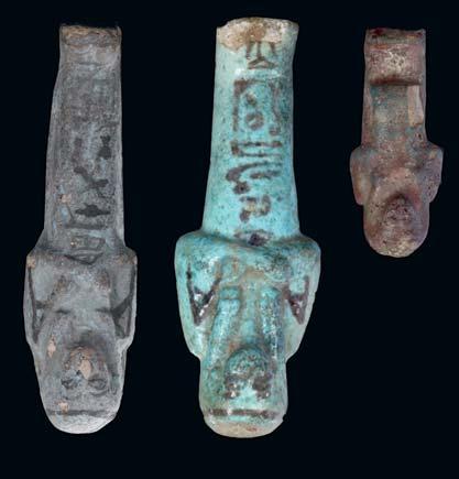 12 THREE EGYPTIAN GLAZED COMPOSITION SHABTIS Third Intermediate Period, 21st-23rd Dynasty, circa 1050-730 B.C. Including a bright blue glazed worker shabti with a fillet, holding two picks and a cross-hatched seed bag across the back, 11.