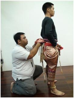 Figure 19. A costume artist attaching the monkey s tail Figure 20. The dressed monkey 3.