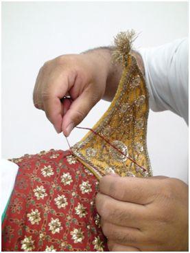 Figure 9. Stitching the inthorn-tanu into place Step Twelve: The krong kaw, similar to an Egyptian usekh, is attached to decorate the performer s neck area.