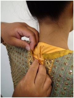 Figure 13. The pa-hom nang being stitched together at the back of the heroine Step Five: The pa-hom nang is stitched to the inner shirt at the front of the performer (Figure14). Figure 14.