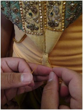Step Seven: The krong kaw is attached to decorate the performer s neck area. The female krong kaw is wider than the male version because the heroine does not wear inthorn-tanu.
