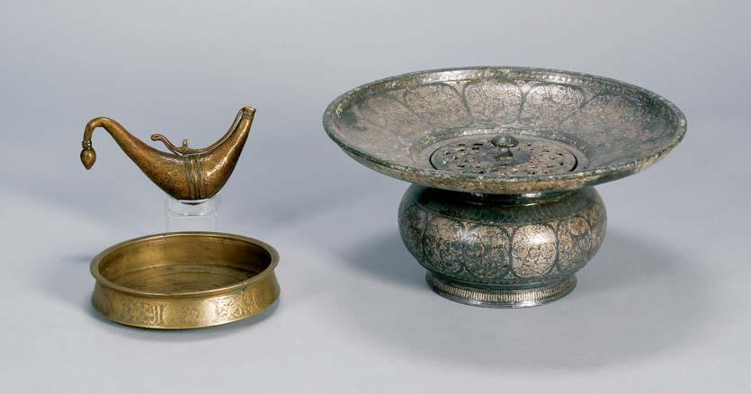 772 773 772. Two Islamic Bronzes, a small basin, Mamluk style, decorated with hares and Arabic script; and a flintlock primer, dia. 7, lg. 7 773.