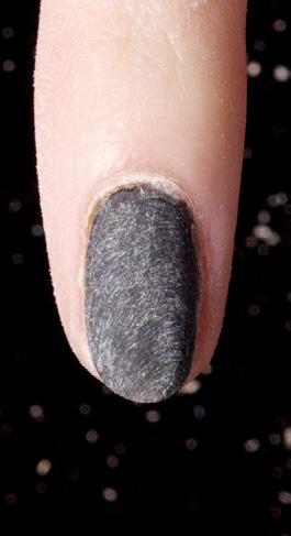 the entire nail and the surrounding skin. Focus on the cuticle area.