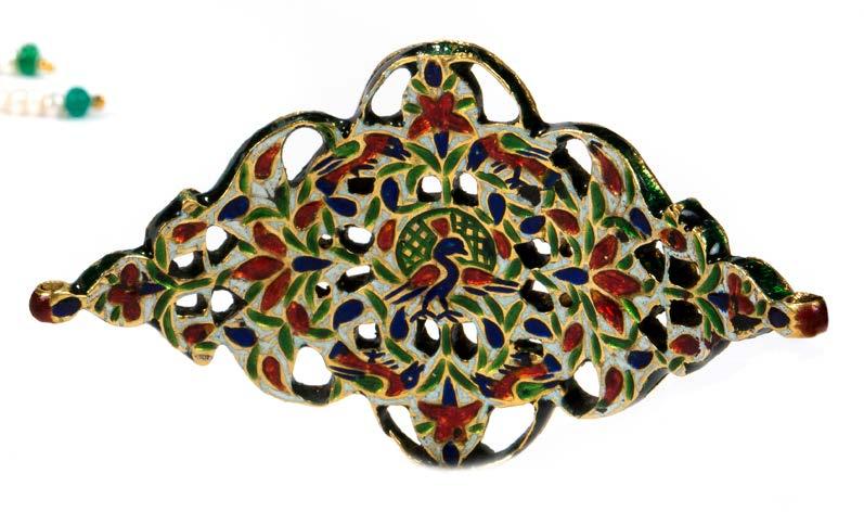 The reverse is enameled in the champlevé technique with red and blue flowers, green