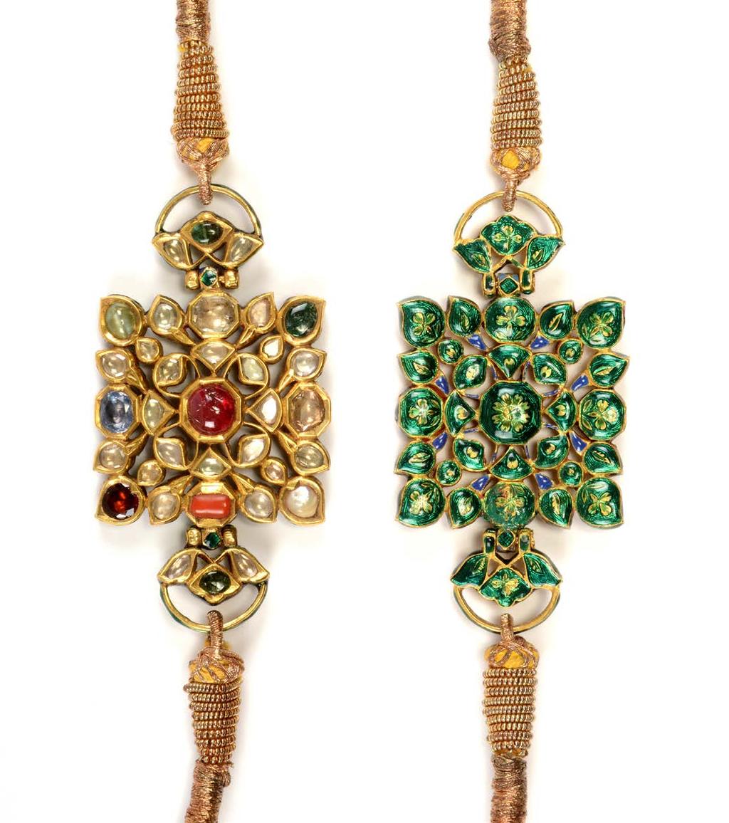 Baju Bands North India, circa 1900 A pair of gold, open worked BAJU BANDS, the front kundan set with the classic Hindu planetal gemstone arrangement NAVA RATNA, a central ruby, rounded