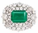 A gem worthy of special distinction 403 402 402 Platinum, Emerald and Diamond Brooch entering one rectangular step-cut emerald approximately 6.43 cts., flanked by 2 round diamonds approximately 1.