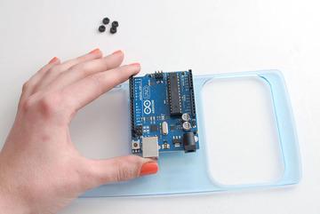 Place the hex nuts atop the Arduino and tighten the screws with a