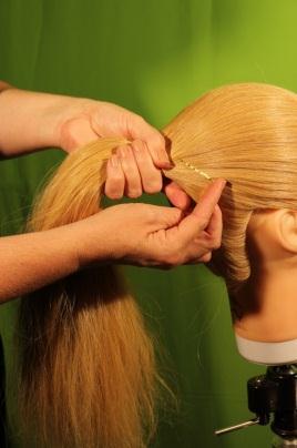 Three: Gather the hair into one hand and continue to direct into the position the pony tail will sit on the head.