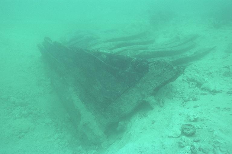 a wooden truck or parrel, and glass bottle bases were all discovered while removing the overburden covering the hull.