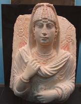 Stone (gypsum, basalt, alabaster), wood and metal (gold, silver) statues: Women with hats or elaborate headdresses. Men are typically bald and/or bearded. Clothing may be plain, layered or wavy.