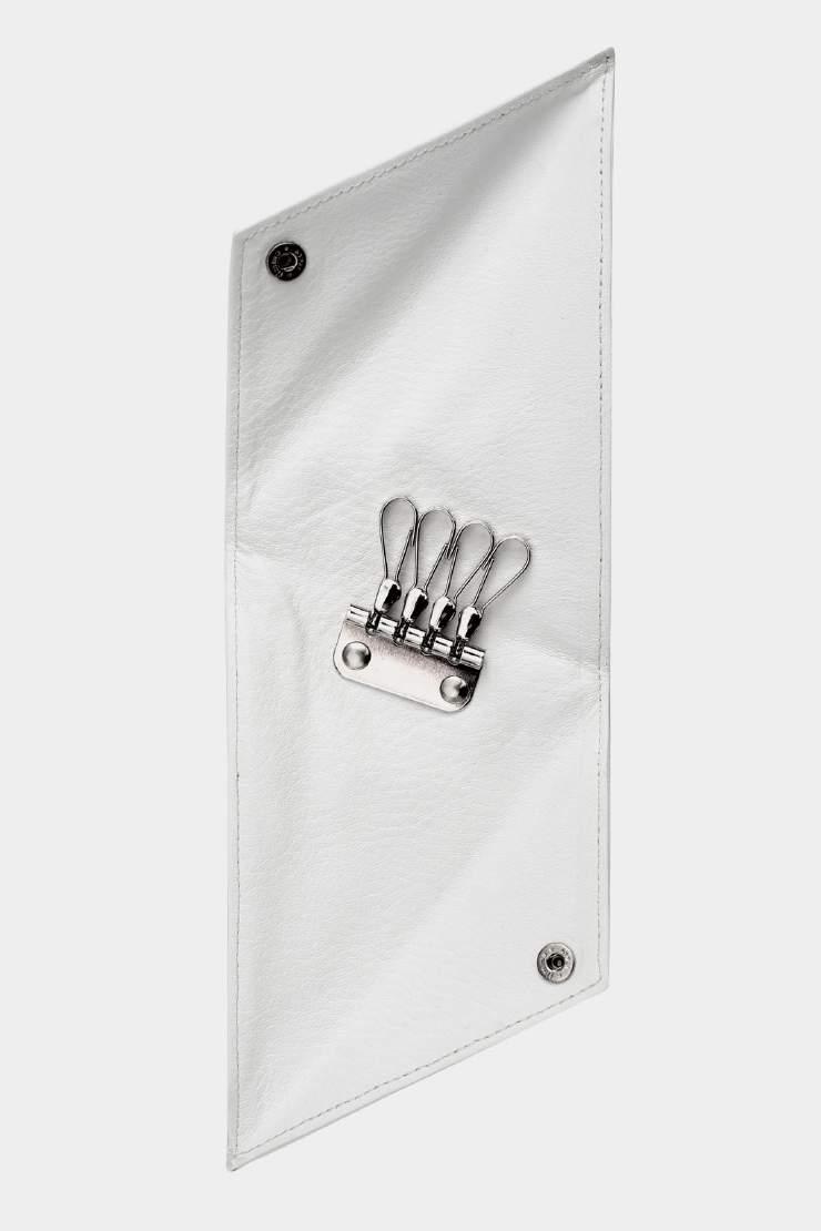 OA 02-2 Triangular Key Holder Folded key case in white leather with silver snap buttons.