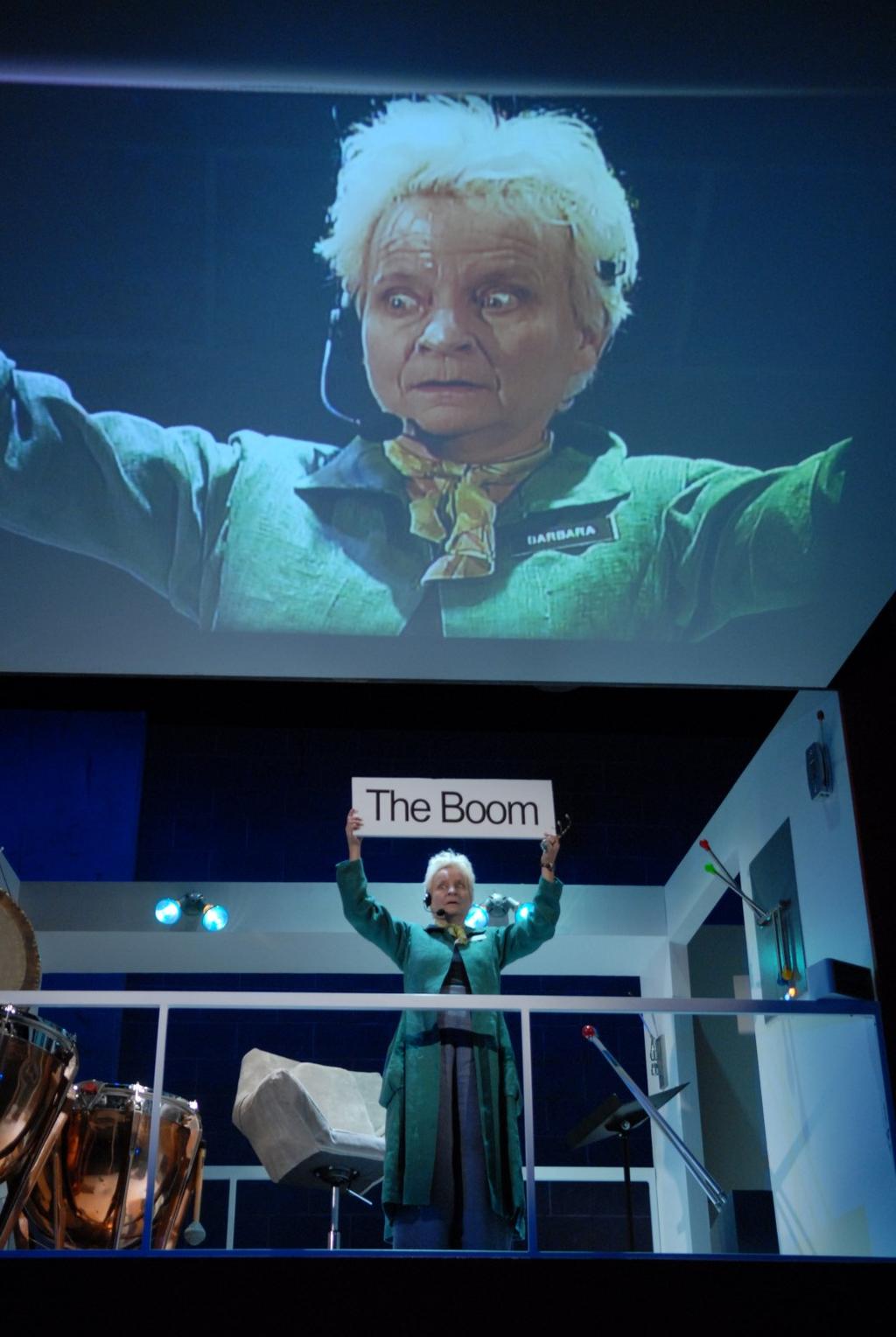 During the Boom: Barbara is remembers that she is not supposed to talk to the audience, and holds up the required sign