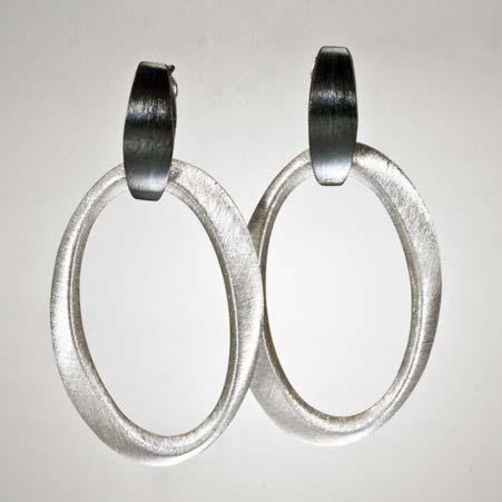 Price: $88 Artist: Korczynski Name: Oval Dangle Earrings in Polished & Oxidized Sterling Silver Item # 7554 ALU: KSK47 WHT BLK Description: Sterling Silver Oxidized Open Oval In