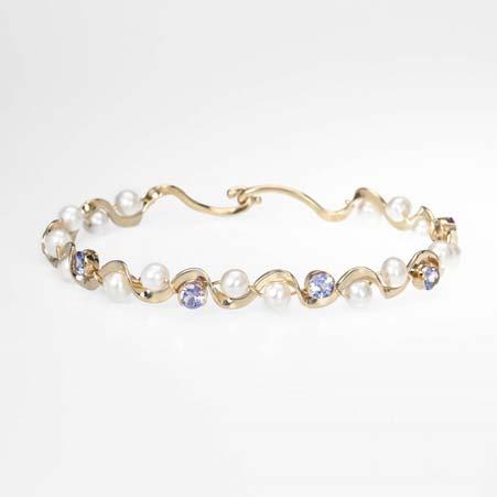 Artist: Tom Kruskal Name: Ruffle Bracelet with Pearls & Pink Sapphires in 14kt Yellow Gold Item # 1641 ALU: ZMB025GS 7 inches long Sapphire Description: 14kt Yellow Gold Hand Forged Five Oval 6X4mm