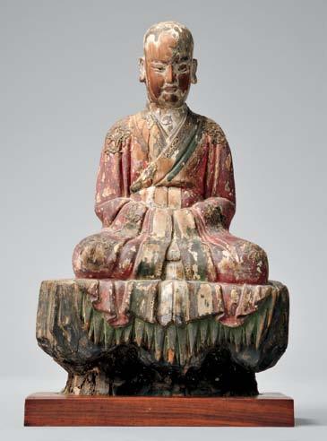432 Polychrome Giltwood Figure of a Seated Guanyin, China, possibly Song dynasty, 11th/12th century, seated on a lion above rockery that holds a carpet, her face carved with a contemplative