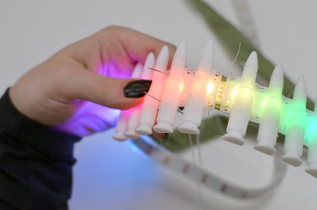 Continue down the length of the NeoPixel strip, tiling on more 3D flexible pieces as you go.