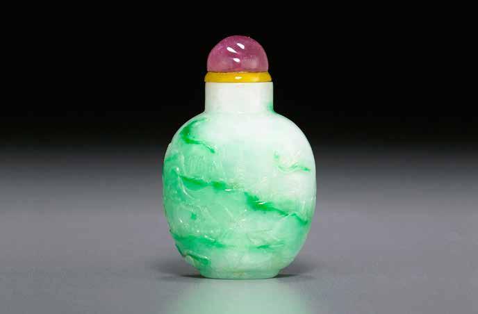 6043 6043 A CARVED JADEITE LANDSCAPE Well-hollowed, of ovoid form with a cylindrical neck, flat lip, rounded oval foot ring, the side walls carved in relief and incised to depict a