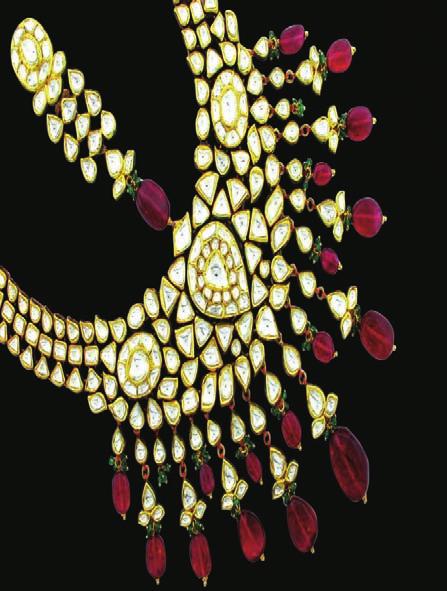The jadau necklace is encrusted with large uncut diamonds and large rubelites.