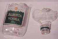 A plastic alcohol bottle can be cut in half to make it look like broken glass. You can also use parts of the bottle for fake glass (as above).