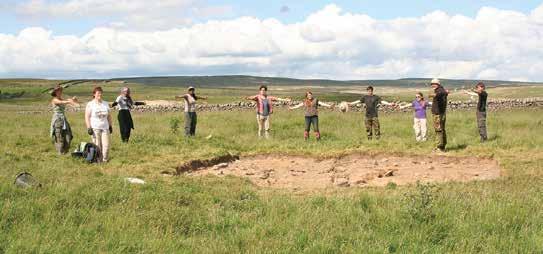 Students standing on the outline of the Neolithic house of dump construction and the location of another previous excavation in the centre. There are no surviving plans or sections.