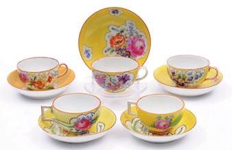 A group of four Meissen Marcolini cups and saucers together with a matched cup and saucer each enamelled with panels of flowers reserved on a yellow ground, saucers 13 cm