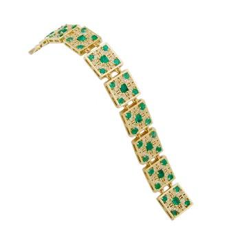 84 18K YELLOW GOLD BRACELET set with 10 emerald cut emeralds and 40 round cut emeralds (8.56ct.t.w.), and decorated with 200 brilliant cut diamonds (2.05ct.t.w.) length 7.25 18.4 cm., 47.