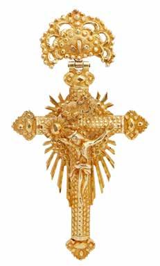 and applied with the body of Christ, starburst, and panel engraved INRI suspended from a pierced cast openwork floral panel with clip fitting, the reverse with concealed compartment and engraved with