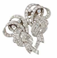 22 Lyon & Turnbull 31 A 1940s diamond set double-clip brooch of scrolling asymmetric design, set throughout with