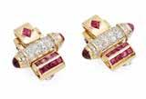 Select Jewellery & Watches 23 34 A pair of 1940s ruby and diamond set ear clips the upper section of each stylised scroll invisibly set with two rows of calibré rubies, the central baton pavé set